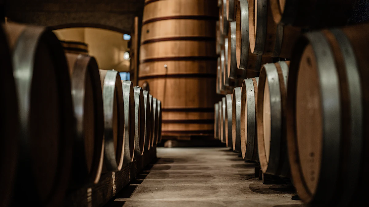 Oak wine barrels stacked in rows in a dimly lit cellar