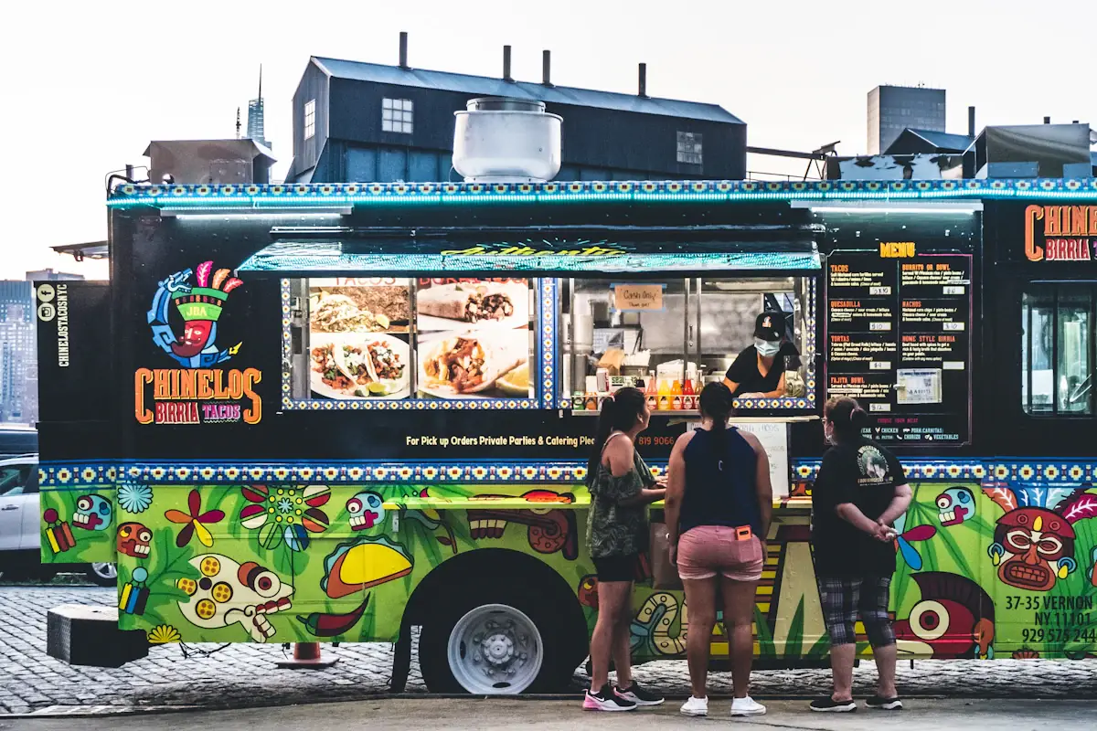 A colorful Portland food cart serving customers through its open window