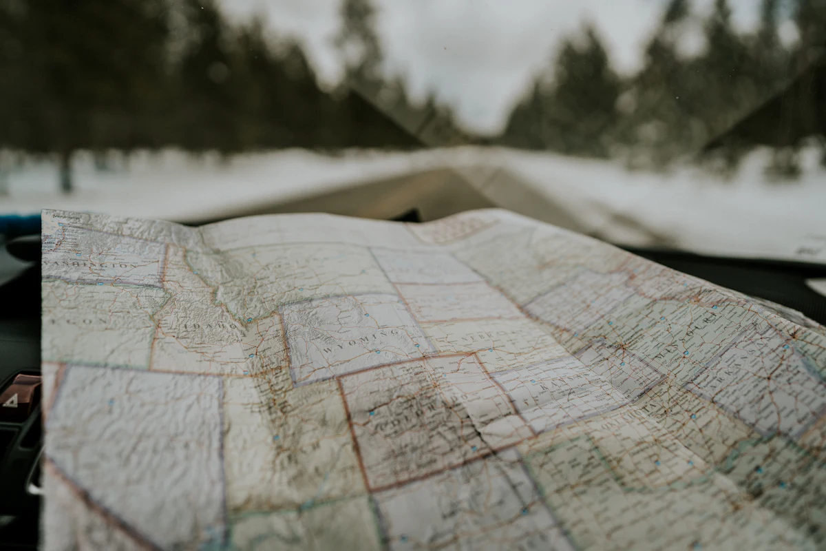 A travel map spread out on a table with notes for planning a food and wine trip