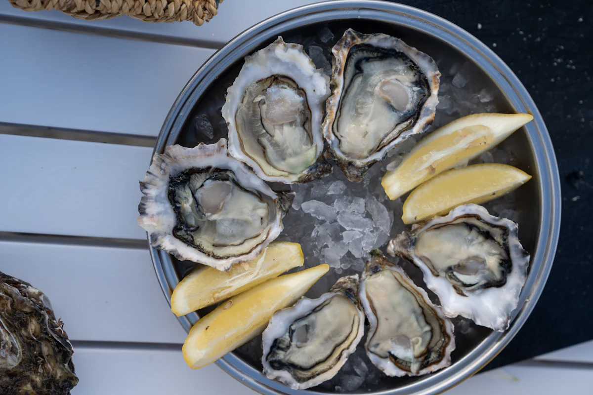 Freshly shucked Pacific Northwest oysters on crushed ice with lemon wedges