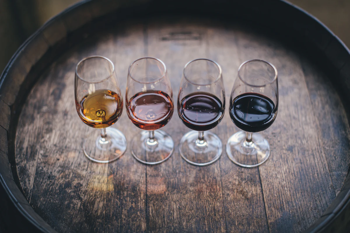 A flight of wine glasses lined up on a table for a guided tasting class